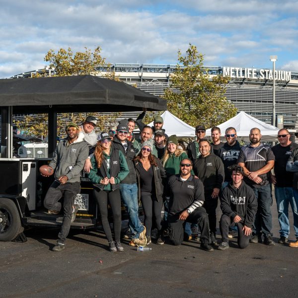 TAPT Events & Tailgate Staff posing in front of Metlife stadium